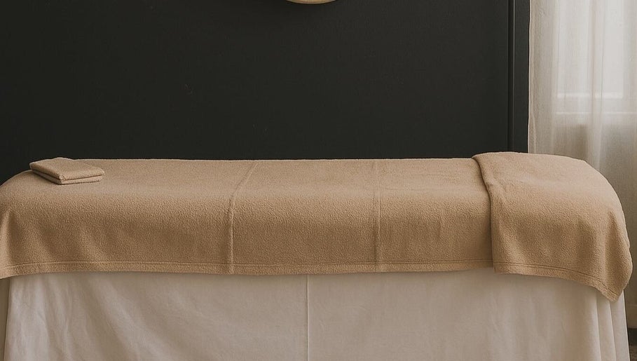 Calm massage table setup at The Grounding Room, Chatsworth, Queensland, AU, showcasing minimalist decor.