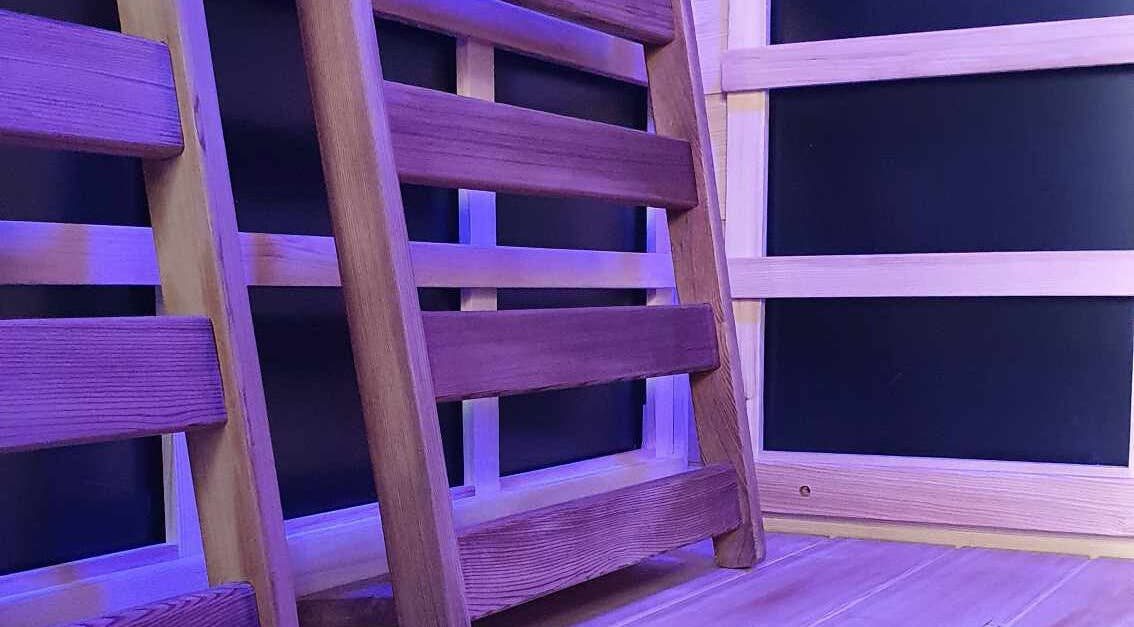 Wooden sauna interior with calming light at The Grounding Room, Chatsworth, Queensland, AU.
