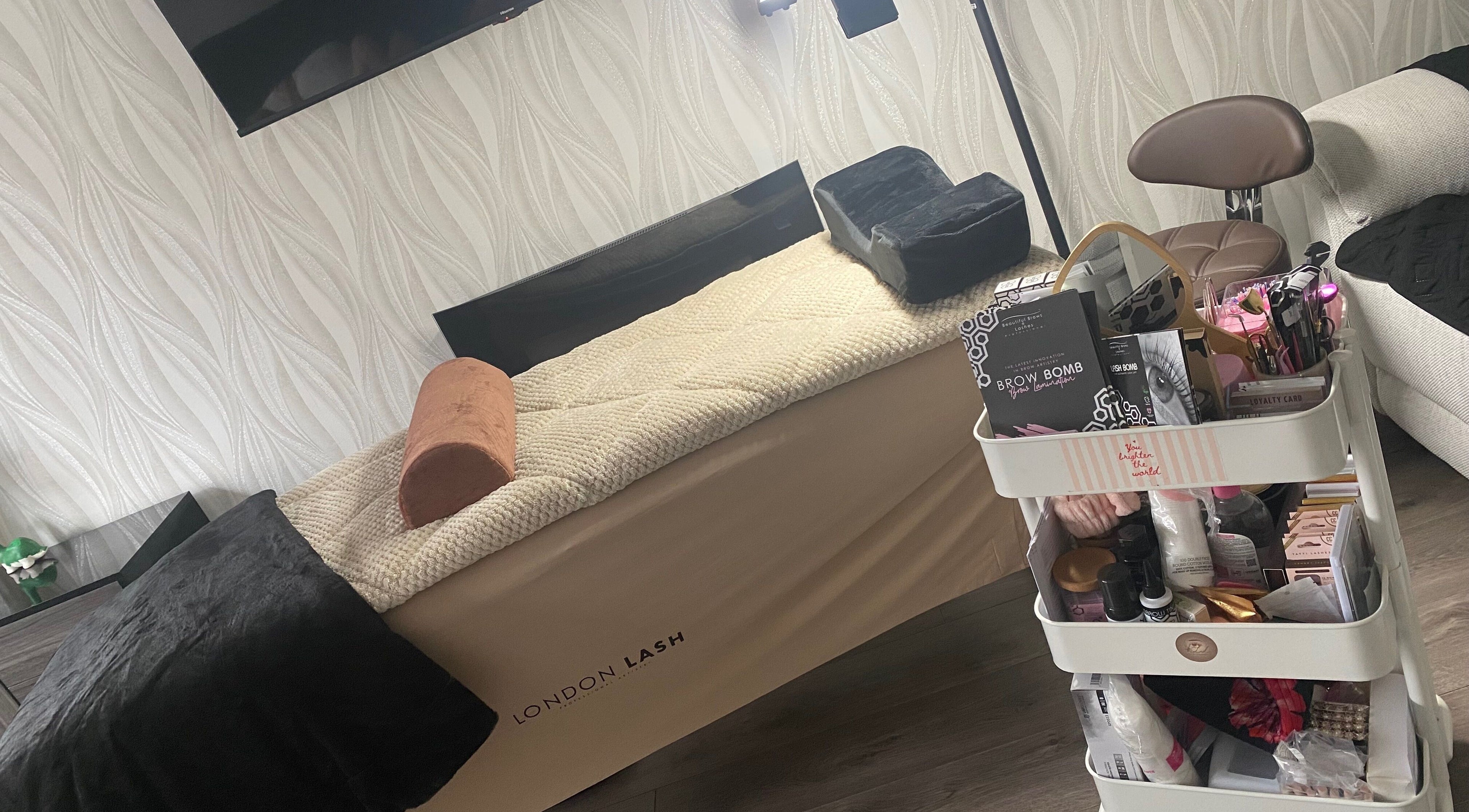 Luxurious treatment room at KLL Lashes and More, Stafford, England, with beauty products and cozy decor.
