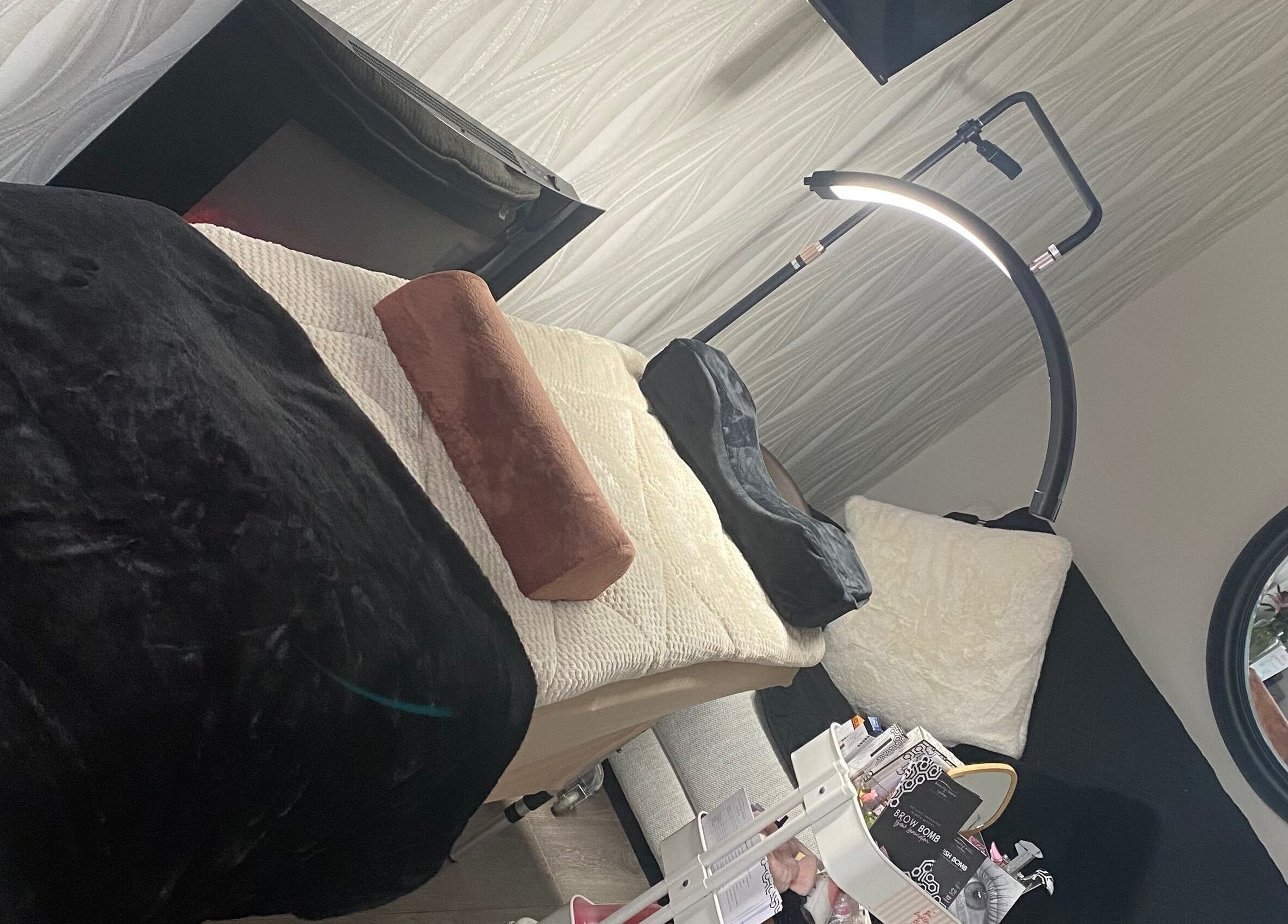Relaxing treatment room at KLL Lashes and More, Stafford, England, GB with cozy bedding and soft lighting.