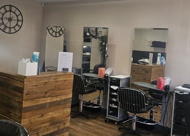 Cozy beauty station at Nikanails Pro, London, England, GB, featuring wooden decor and modern styling chairs.