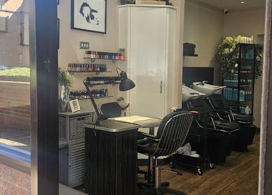 Interior of Nikanails Pro, London, England, featuring nail and hair stations in a modern, inviting setting.
