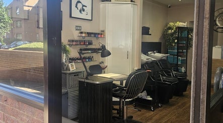 Interior of Nikanails Pro, London, England, featuring nail and hair stations in a modern, inviting setting.