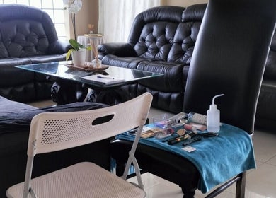 Beauty setup at WhipLashed.gq in Gqeberha, Eastern Cape, ZA, featuring comfortable seating and makeup tools.