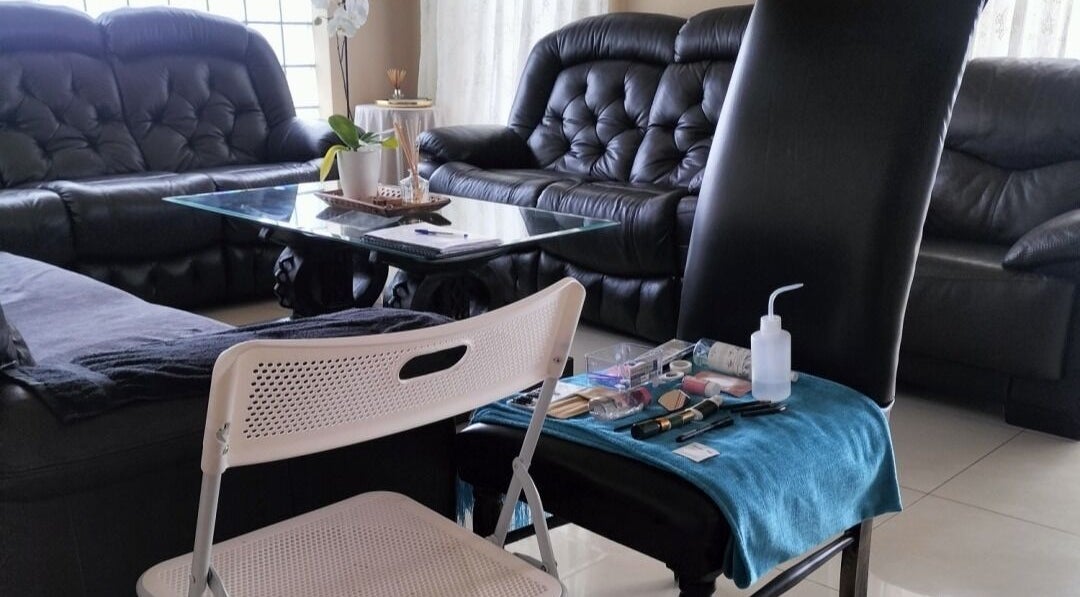 Beauty setup at WhipLashed.gq in Gqeberha, Eastern Cape, ZA, featuring comfortable seating and makeup tools.