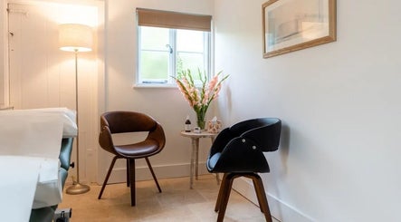 Cozy seating area at Molten&Muse, Hatfield, England, GB featuring elegant chairs and soft lighting.