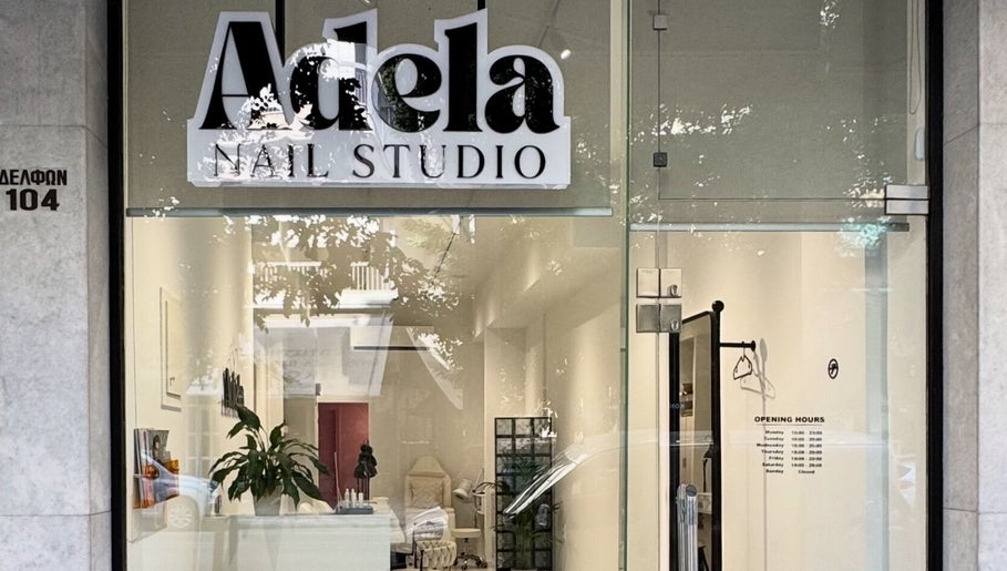 Front view of Adela nail studio, Thessaloniki, GR, highlighting its modern glass entrance.