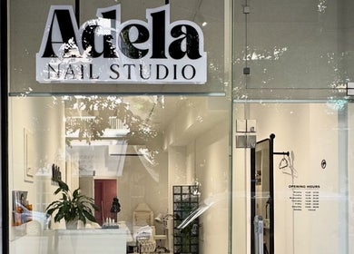Front view of Adela nail studio, Thessaloniki, GR, highlighting its modern glass entrance.