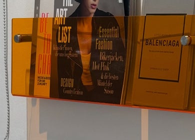 Magazines on a vibrant shelf at Adela nail studio, Thessaloniki, GR, showcasing style and design.