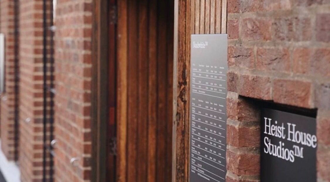 Entrance of Elaine Sadler Skin Health in Warwick, England, GB with visible brick walls and signs.