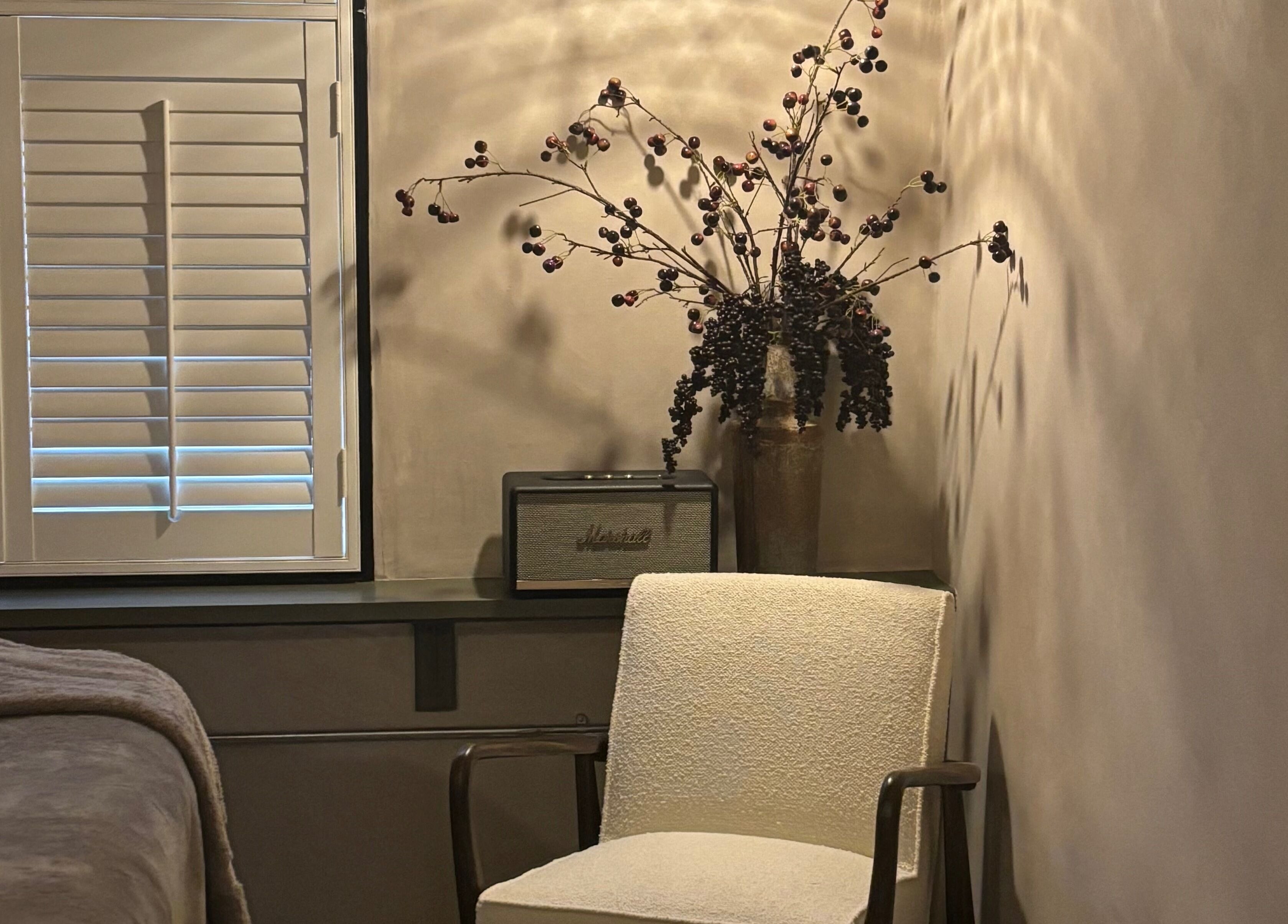 Elaine Sadler Skin Health lounge with white chair and decorative vase in Warwick, England, GB.