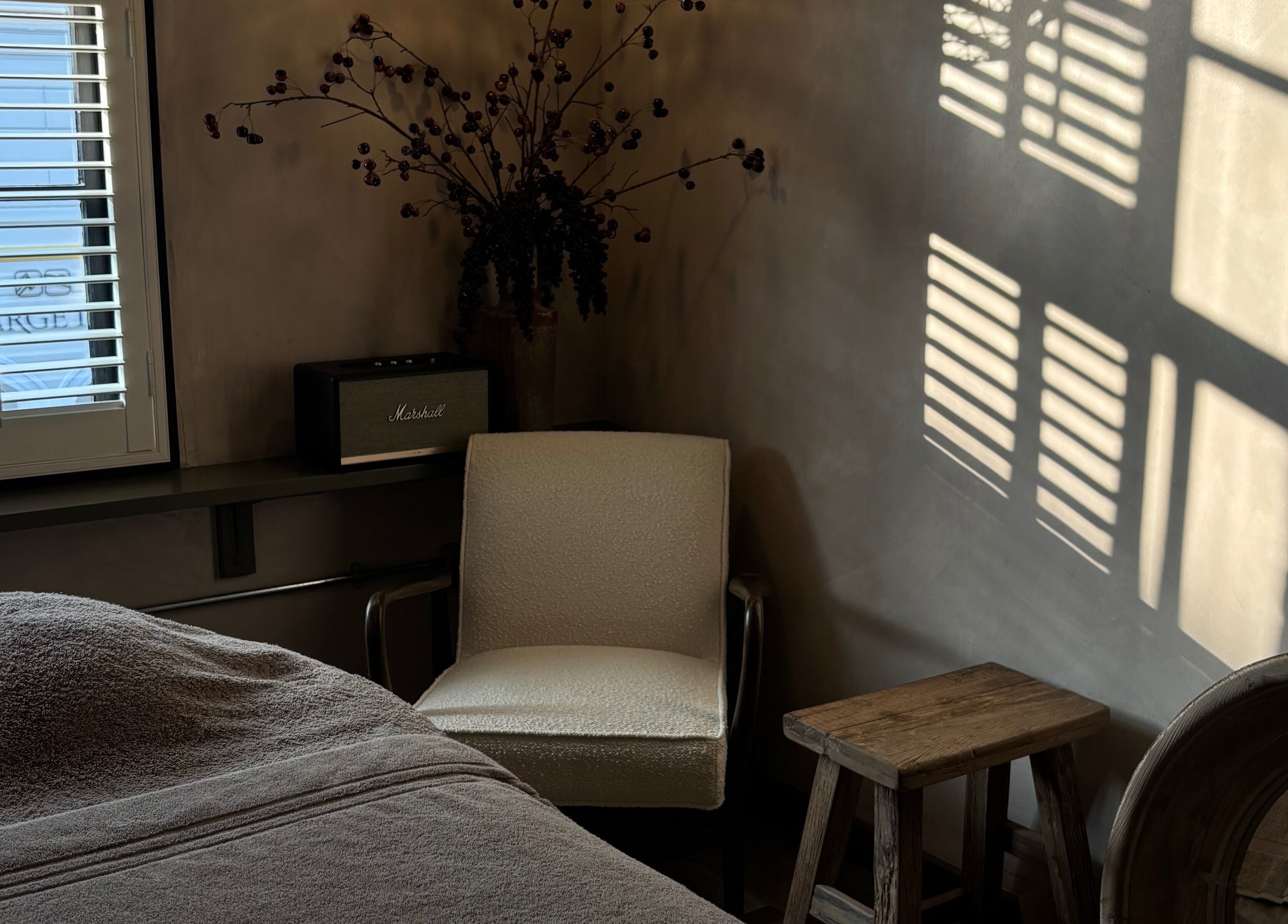 Sunlit corner at Elaine Sadler Skin Health, Warwick, England, GB featuring cozy chair and relaxing ambiance.