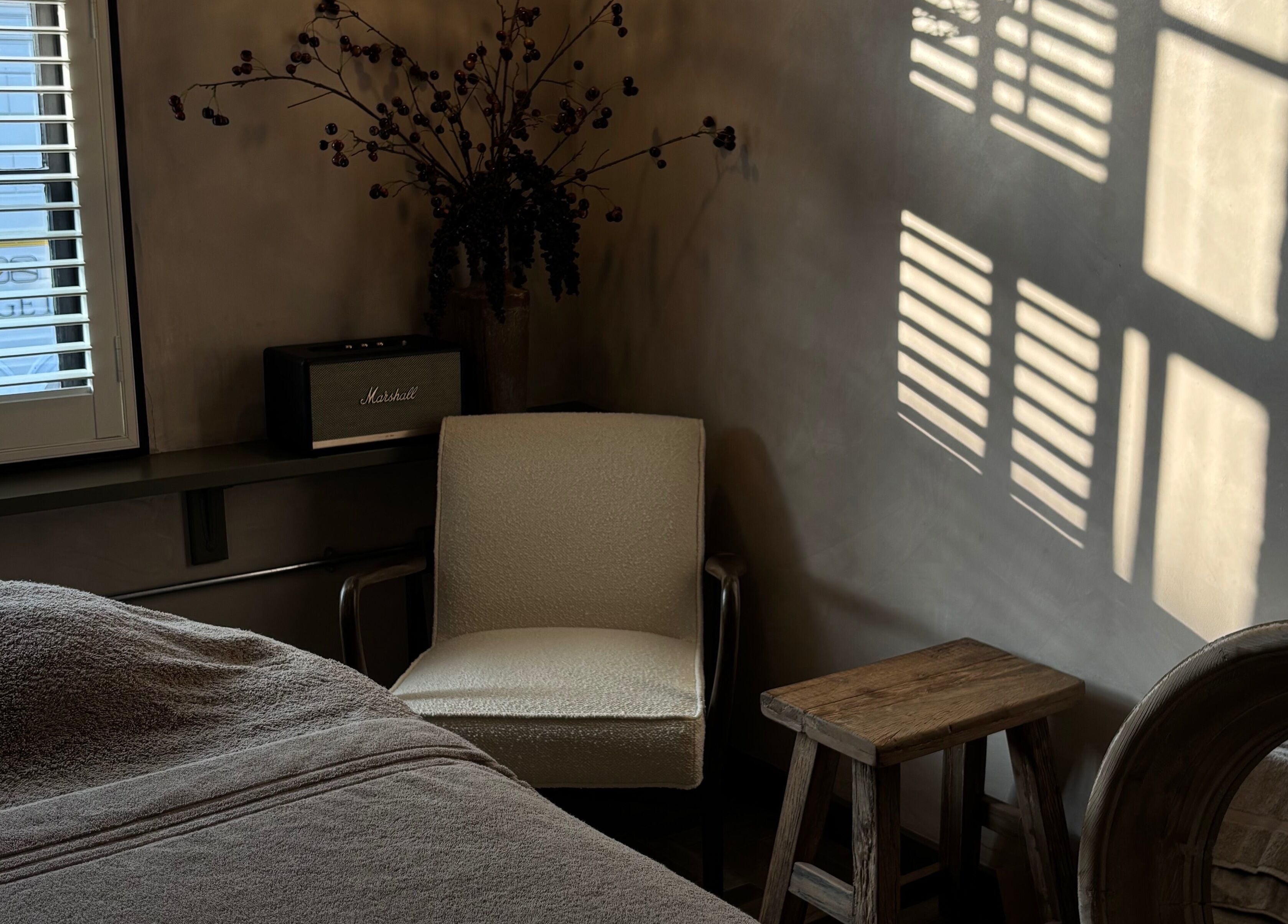 Relaxing corner at Elaine Sadler Skin Health, Warwick, England, GB with comfy chair and window light.