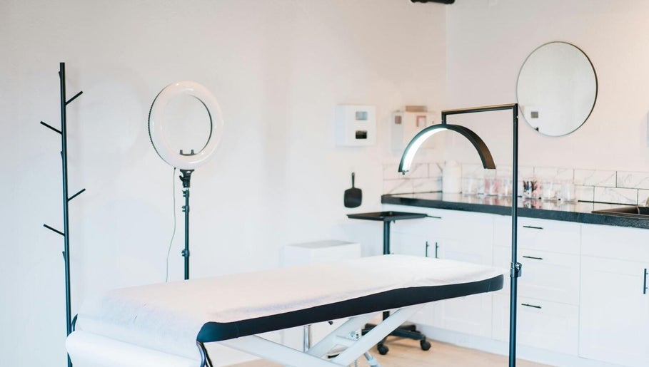 Treatment room at Relive Spa, Al Rayyan, Doha showcasing a modern massage table and elegant decor.