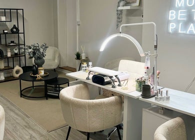 Modern nail salon interior at Nailsbybry, Ampthill, England, GB with elegant decor and cozy seating.