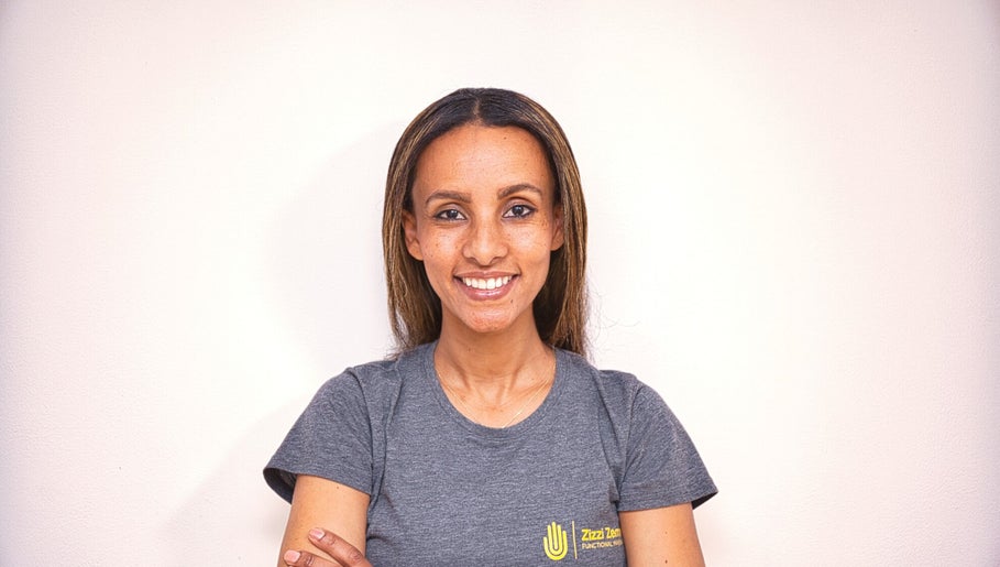 Smiling staff member at Zizzi Zemro Functional Massage, Bradford-on-Avon, England, GB.