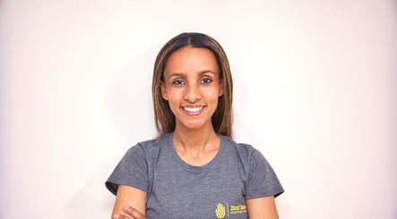 Smiling staff member at Zizzi Zemro Functional Massage, Bradford-on-Avon, England, GB.