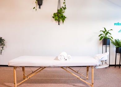Massage room at Zizzi Zemro Functional Massage, Bradford-on-Avon, with table and plants for a soothing ambiance.