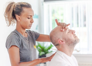 Massage therapist at Zizzi Zemro Functional Massage in Bradford-on-Avon, England, GB providing relaxing head massage.