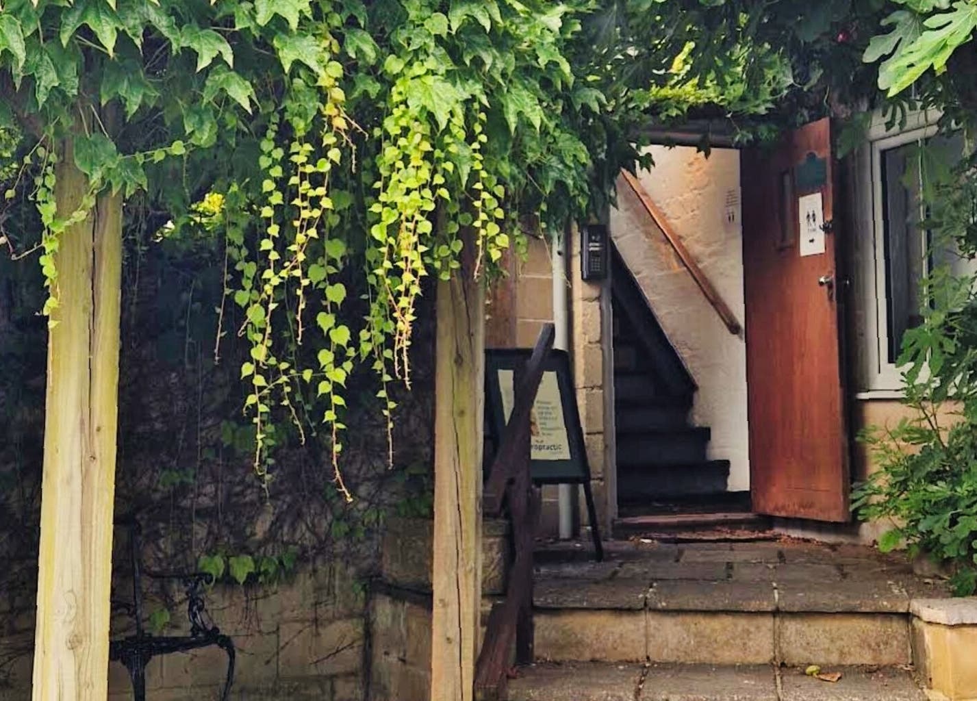 Charming entrance of Zizzi Zemro Functional Massage, surrounded by greenery in Bradford-on-Avon, England, GB.