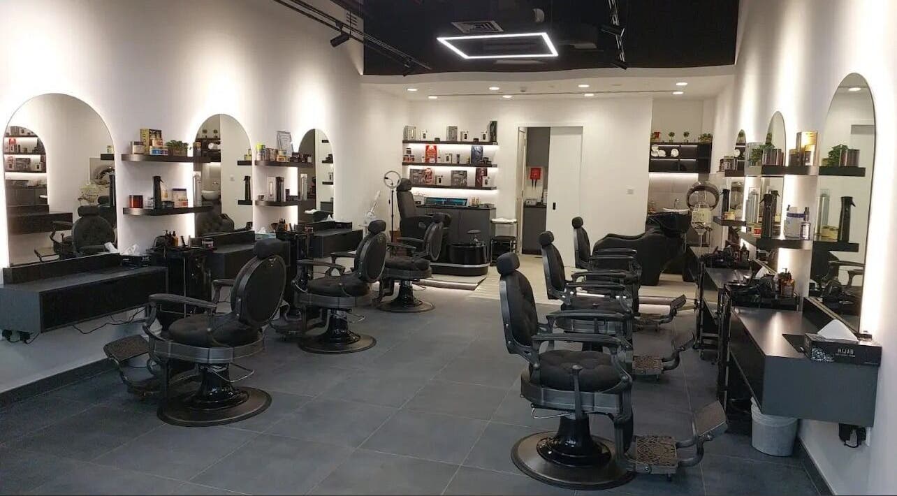 Modern interior of Razor Kings Salon L.L.C, Dubai, Dubai, AE, featuring stylish barber chairs and illuminated mirrors.