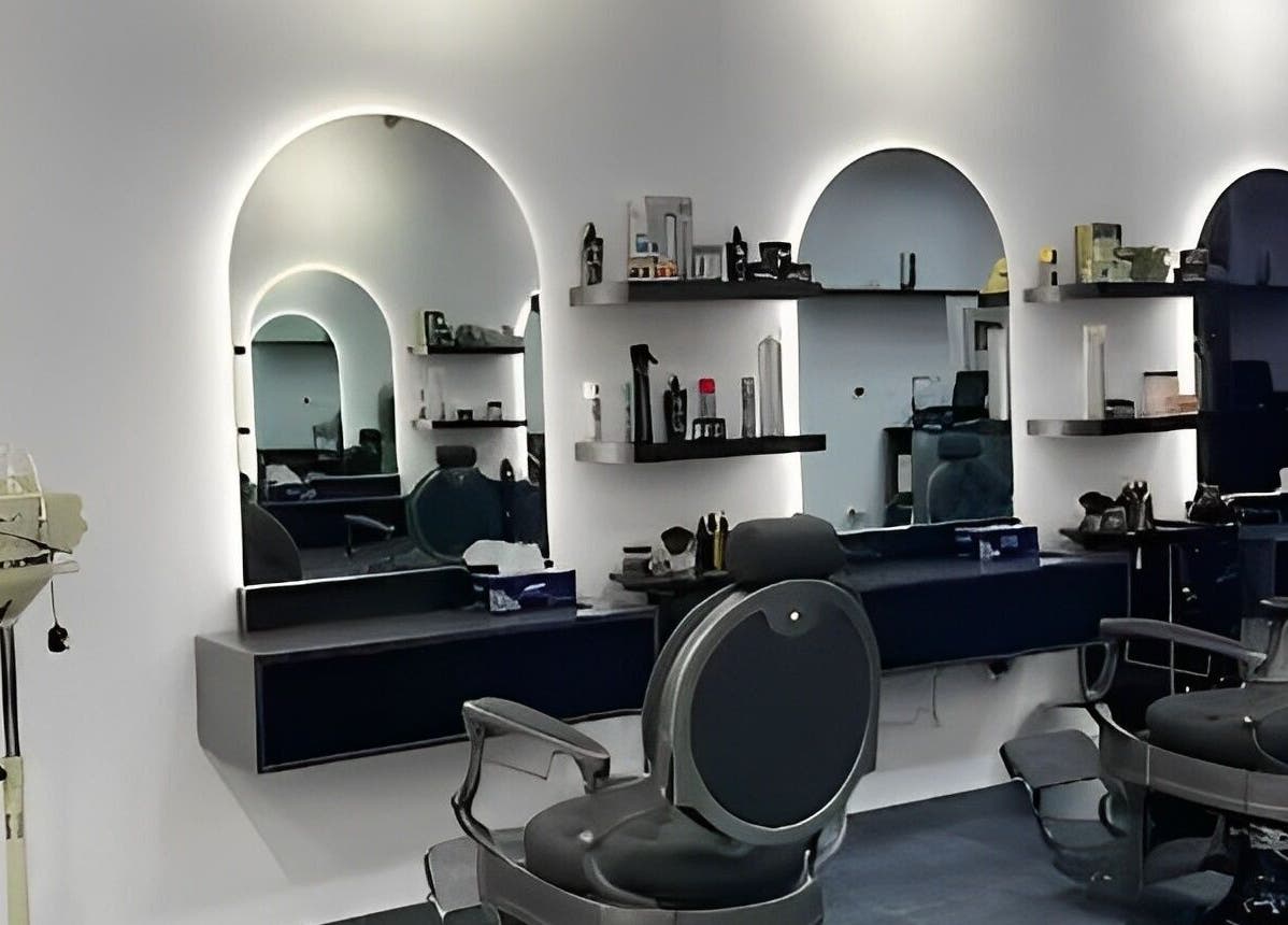 Modern interior of Razor Kings Salon L.L.C, Dubai, Dubai, AE featuring stylish barber chairs and mirrors.