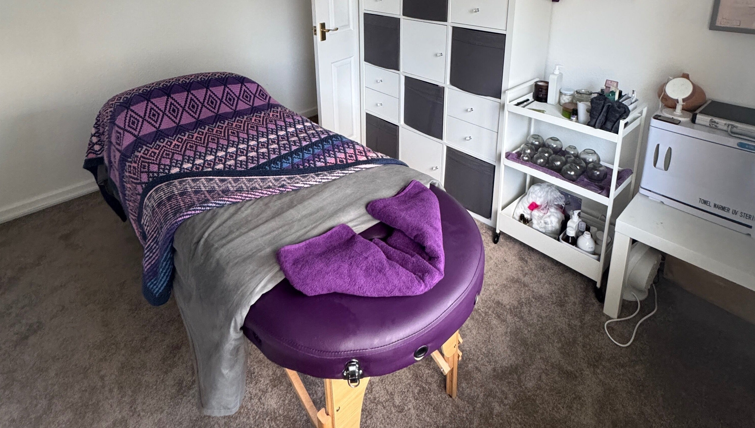 Relaxing massage room at Massage By Ultra in East Grinstead, England, GB, featuring a cozy massage table.
