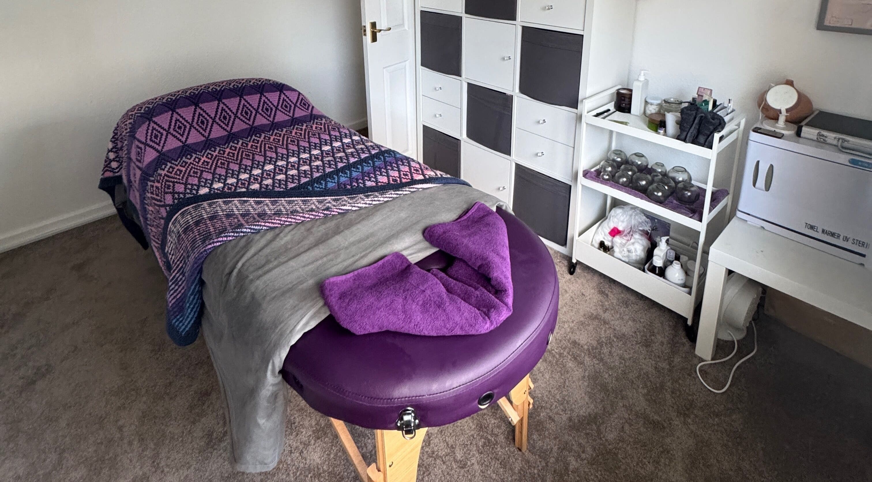 Relaxing massage room at Massage By Ultra in East Grinstead, England, GB, featuring a cozy massage table.