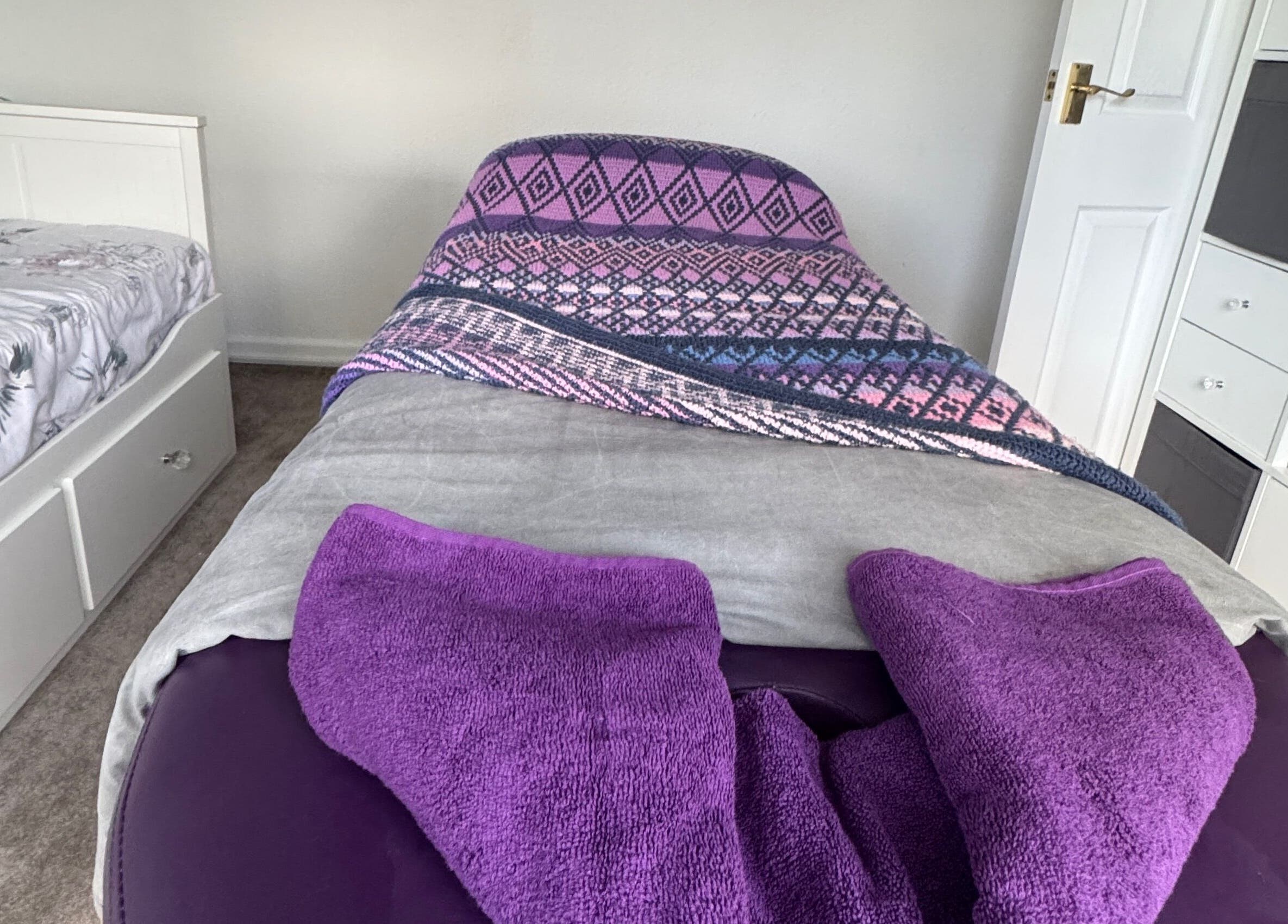 Peaceful massage room at Massage By Ultra, East Grinstead, England, GB, featuring a cozy bed and soothing decor.