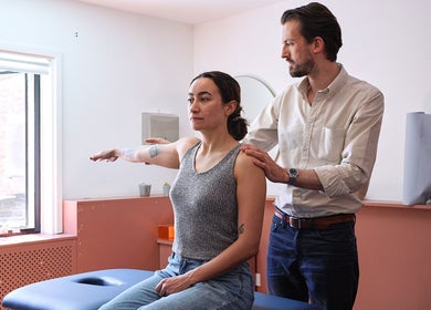 Chiropractor assisting client at South London Chiropractic: East Dulwich, London, England, GB.