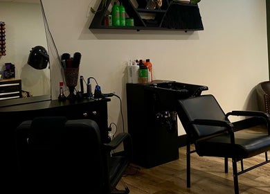 Modern hair styling station at Sacred Beauty, Canal Flats, British Columbia, CA, featuring sleek chairs and products.