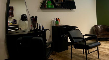 Modern hair styling station at Sacred Beauty, Canal Flats, British Columbia, CA, featuring sleek chairs and products.