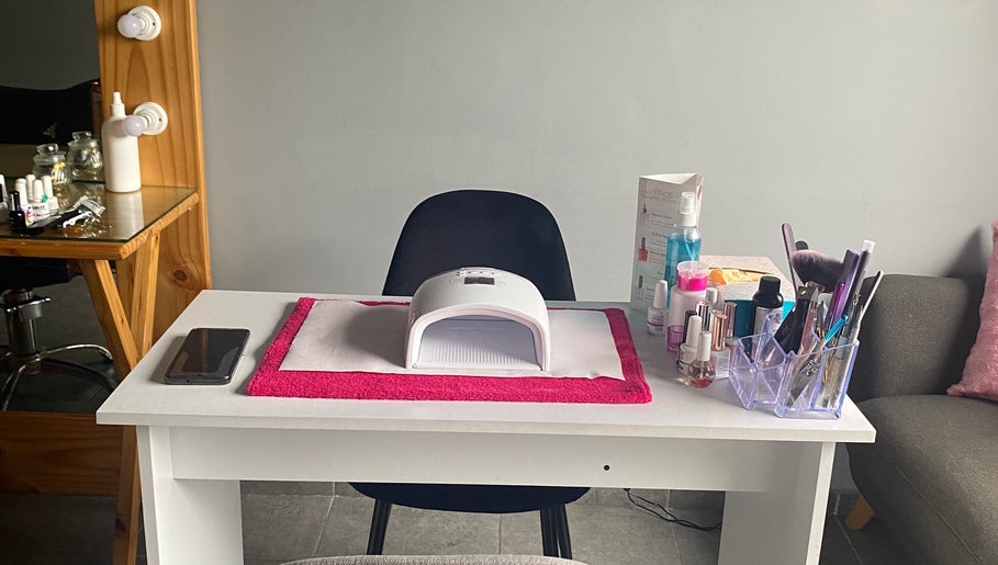 Nail station setup at The Beauty Pond in Cape Town, Western Cape, ZA with tools and polish on a sleek table.