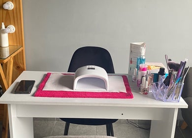 Nail station setup at The Beauty Pond in Cape Town, Western Cape, ZA with tools and polish on a sleek table.