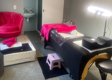 The Beauty Pond's serene spa room in Cape Town, Western Cape, ZA with rich pink accents.