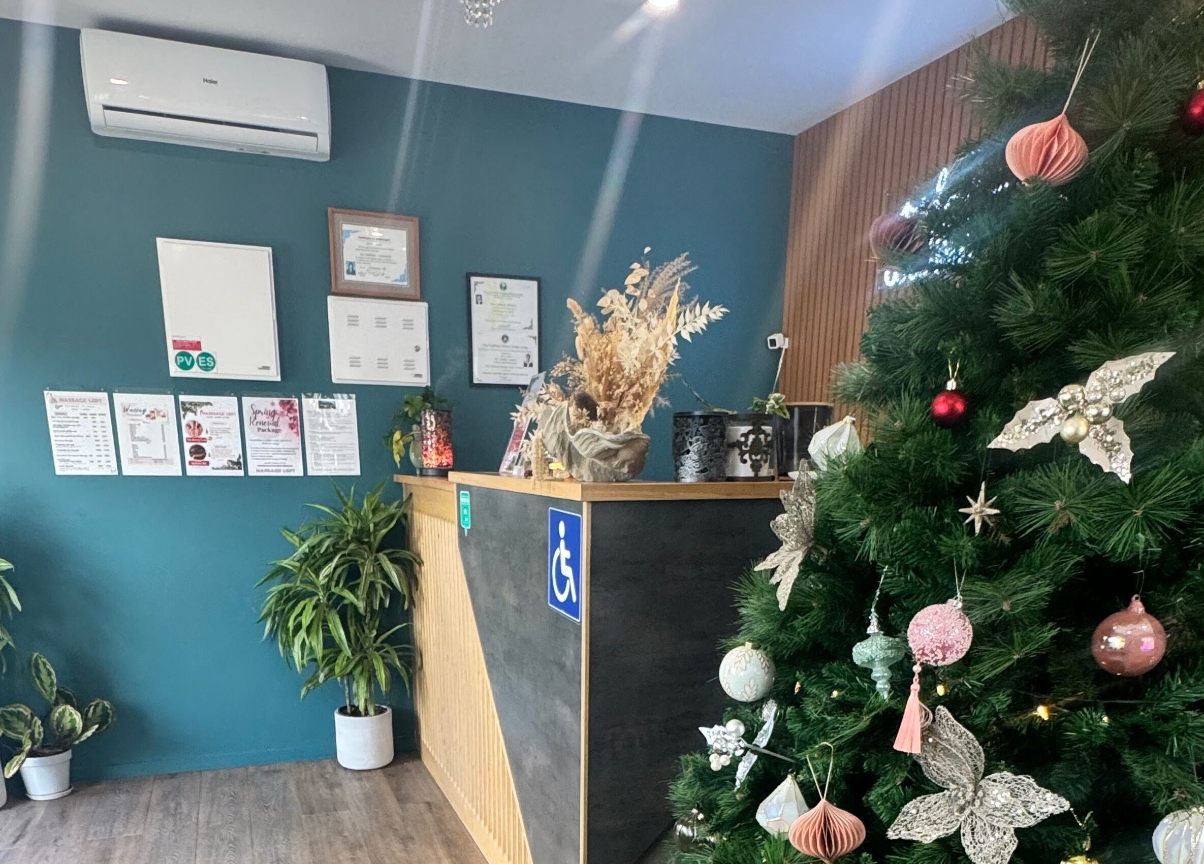 Reception of Massage Loft (Drury) in Auckland, NZ with Christmas decor and greenery.