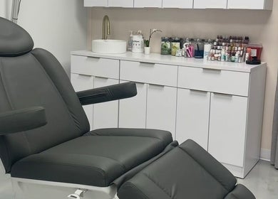 Modern treatment room at Beauty Ink Cosmetic Solutions, Columbus, Indiana, US. Sleek chair and counter area.
