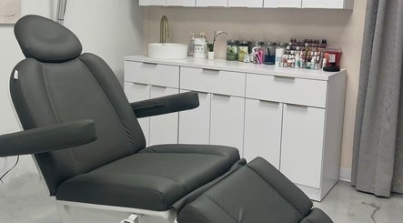 Modern treatment room at Beauty Ink Cosmetic Solutions, Columbus, Indiana, US. Sleek chair and counter area.