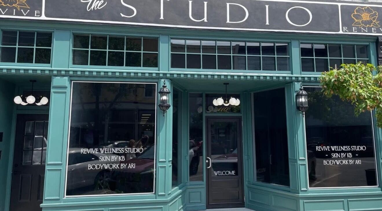 Entrance to Beauty Ink @RevIVe Wellness Studio in Seymour, Indiana, US, featuring elegant teal facade.