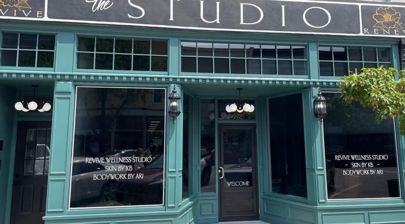 Entrance to Beauty Ink @RevIVe Wellness Studio in Seymour, Indiana, US, featuring elegant teal facade.