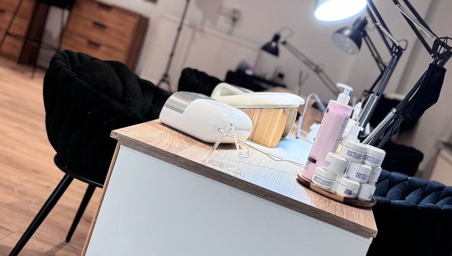 Nail care station at Lunea Beauty By Yvonne in Liverpool, England, GB, featuring creams and a lamp.