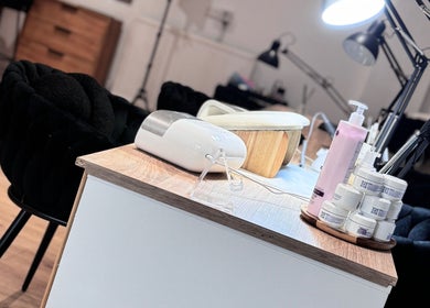 Nail care station at Lunea Beauty By Yvonne in Liverpool, England, GB, featuring creams and a lamp.