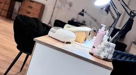 Nail care station at Lunea Beauty By Yvonne in Liverpool, England, GB, featuring creams and a lamp.