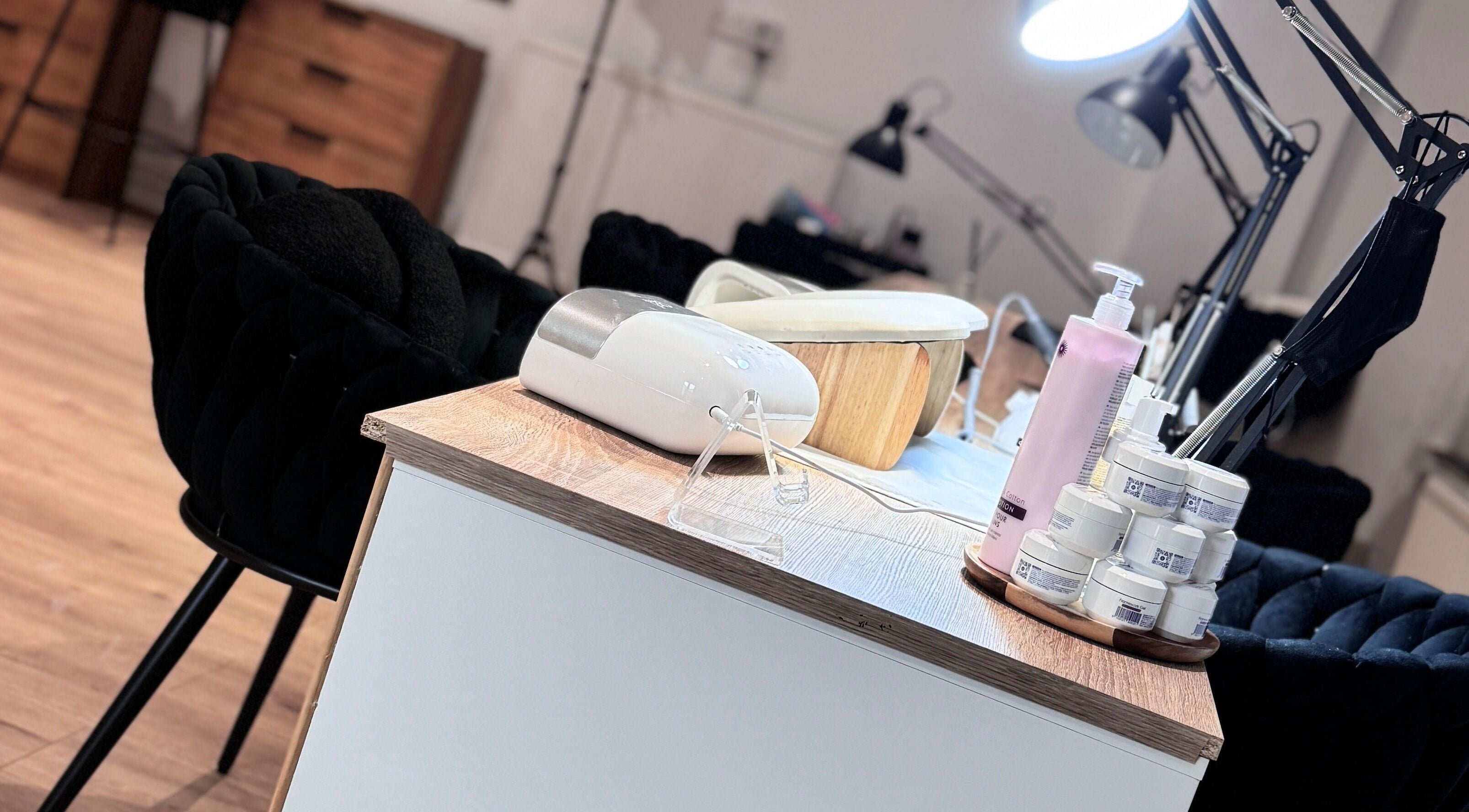 Nail care station at Lunea Beauty By Yvonne in Liverpool, England, GB, featuring creams and a lamp.