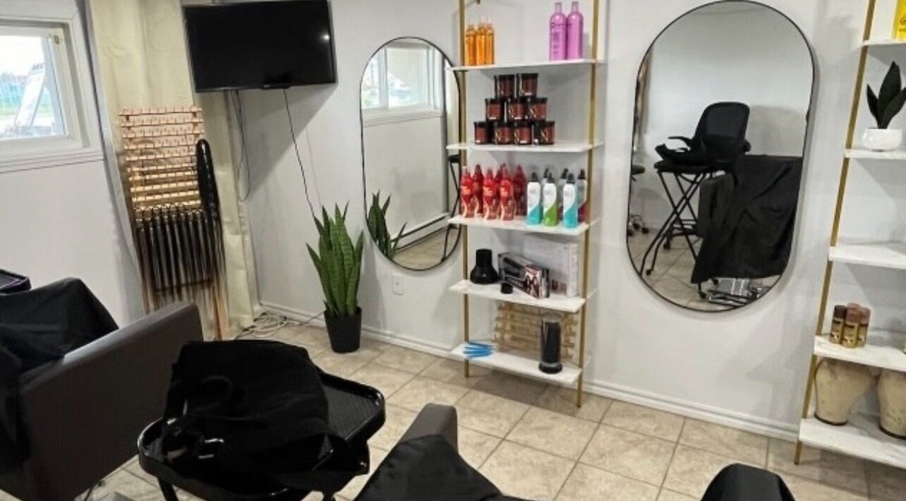 Interior of Audiizhair salon in Repentigny, Québec, CA showing modern decor and hair products display.