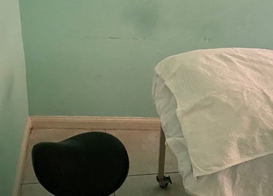 Treatment room at Subrina’s Golden Touch in Kingston, St. Andrew Parish, with a prepared massage table.