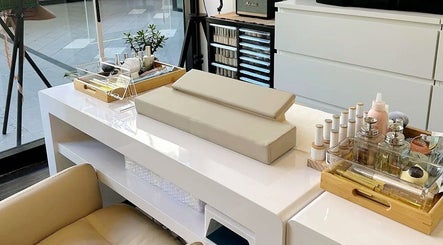 Manicure station at Genevieve's Nail & Eyelashes Salon in Southport, Queensland, AU with nail polish and tools.