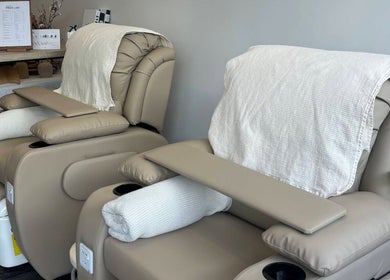Cream-colored pedicure chairs at Genevieve's Nail & Eyelashes Salon, Southport, Queensland, AU, offering comfort.