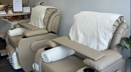 Cream-colored pedicure chairs at Genevieve's Nail & Eyelashes Salon, Southport, Queensland, AU, offering comfort.