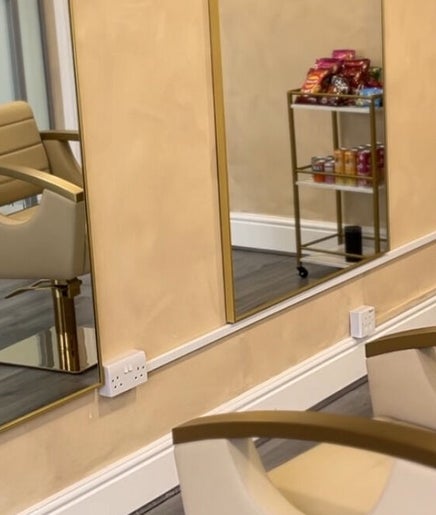 Modern salon interior at braidsbyashlee, Birmingham, England, GB featuring elegant chairs and mirrors.